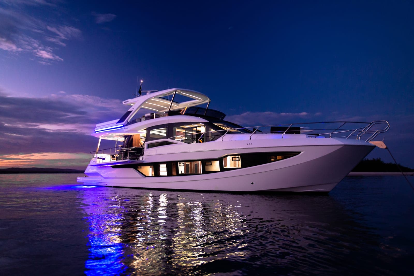 Galeon 640 Fly yacht at dusk in San Diego Bay, operated by Artizia Yachts